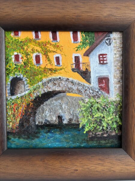 A painting of a bridge and houses in the background.